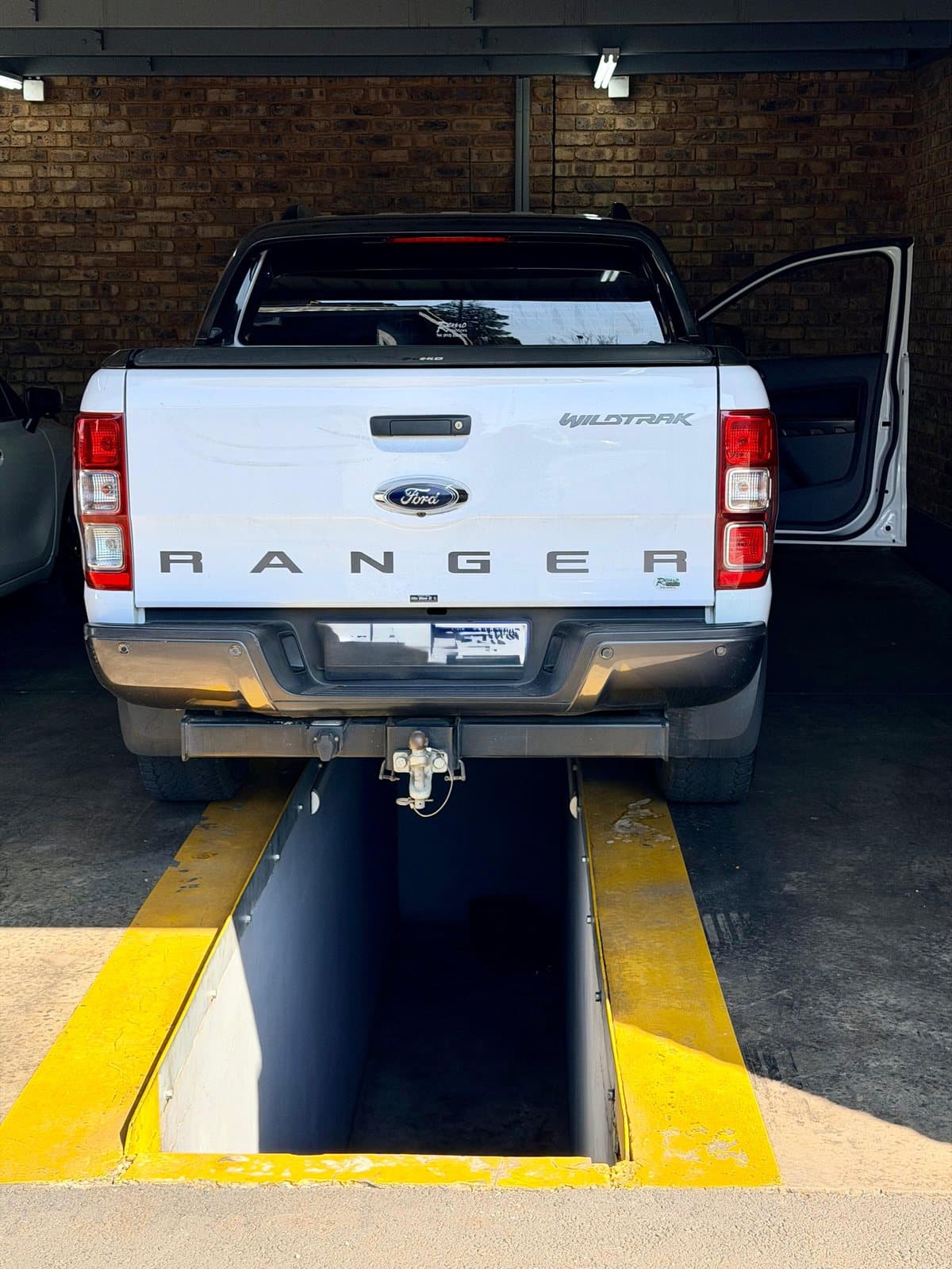 A bakkie over the inspection pit in the workshop at Vision Motors, Wonderboom South, Pretoria