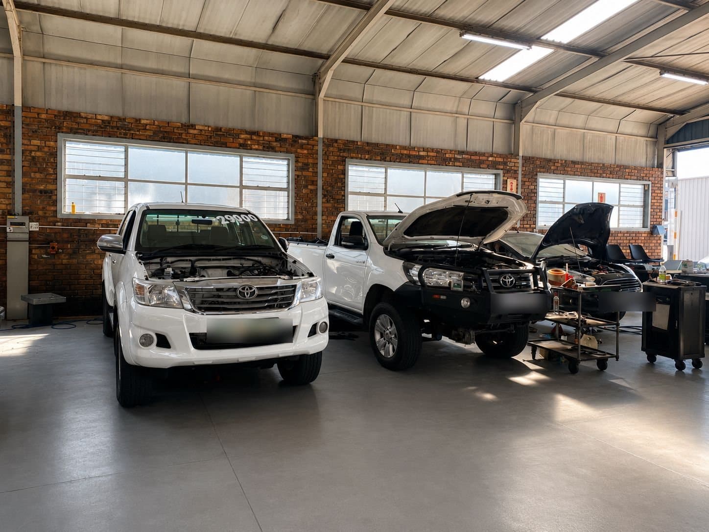 Customer vehicles in the workshop bays at Vision Motors, Wonderboom South, Pretoria