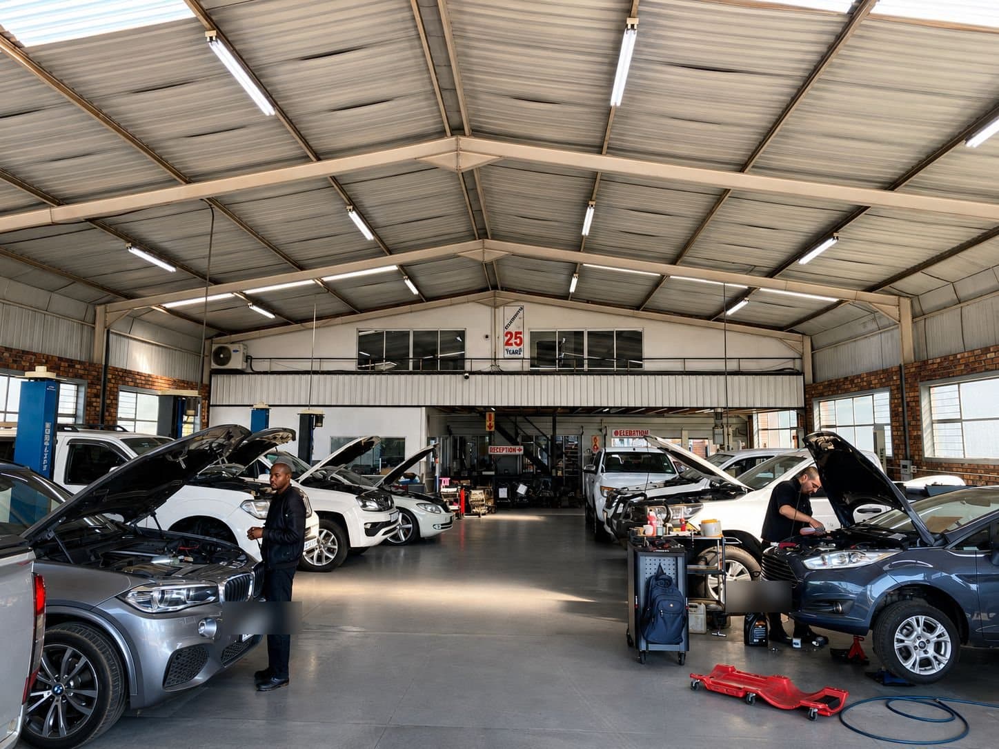 Inside the Vision Motors workshop in Wonderboom South, Pretoria, with customer vehicles up for repair
